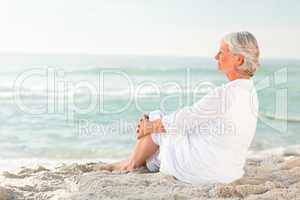 Woman who is sitting on the beach