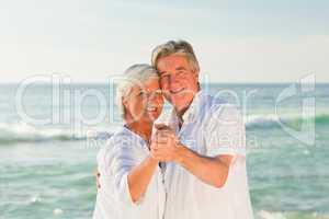 Mature couple dancing on the beach