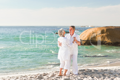 Retired couple dancing on the beach