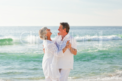 Retired couple dancing on the beach