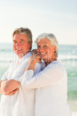 Woman hugging her husband at the beach