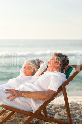Elderly couple relaxing in their deck chairs