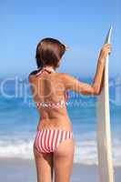 Adorable woman with her surfboard