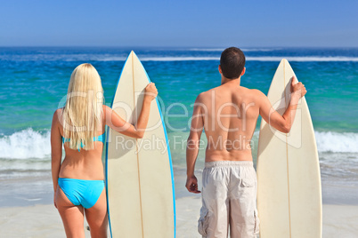 Couple with their surfboards