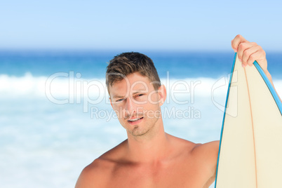 Handsome man with his surfboard
