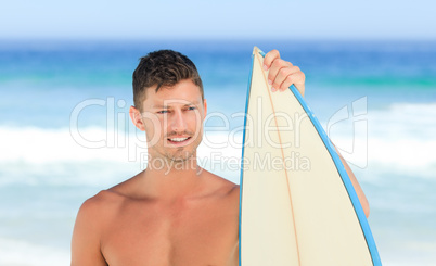 Handsome man with his surfboard