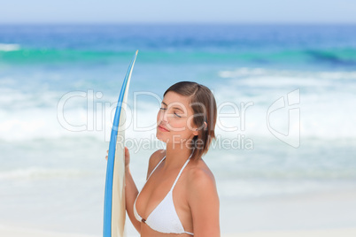 Cute woman with her surfboard