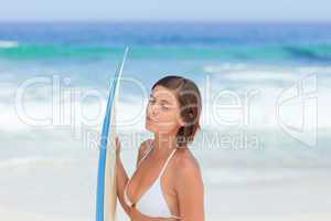 Cute woman with her surfboard