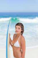 Cute woman with her surfboard