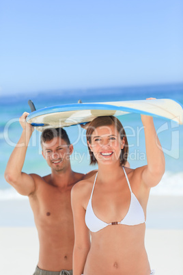 Lovers with their surfboard