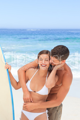 Couple with their surfboard