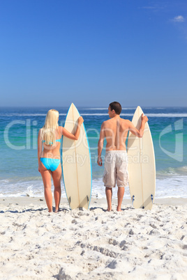 Lovers with their surfboards