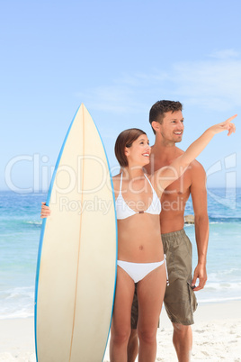 Couple with their surfboard