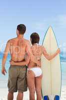Couple with their surfboard