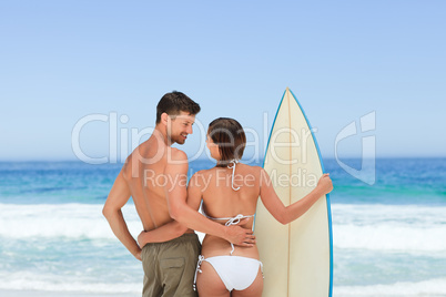 Couple with their surfboard