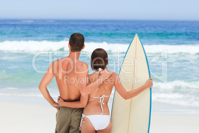 Couple with their surfboard