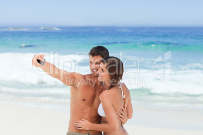 Lovers with their camera at the beach