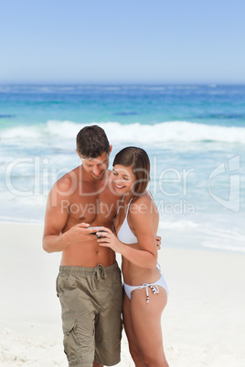 Lovers with their camera at the beach