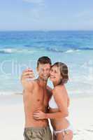 Lovers with their camera at the beach