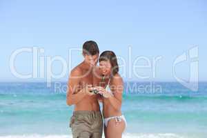 Lovers with their camera at the beach