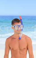 Man with his mask at the beach