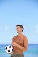 Man with his ball at the beach