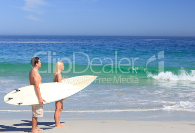 Lovers with their surfboards