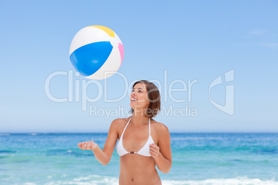 Lovely woman with her ball on the beach