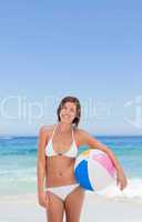 Cute woman with her ball on the beach