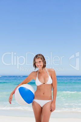 Cute woman with her ball on the beach
