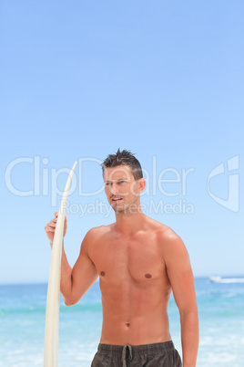 Man posing with his surfboard