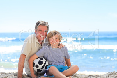 Grandfather and his grandson with a ball