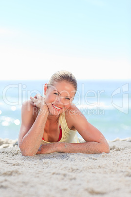 A woman sunbathing at the beach