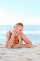 A woman sunbathing at the beach