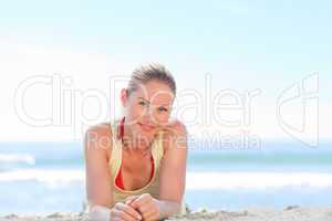 A woman sunbathing at the beach