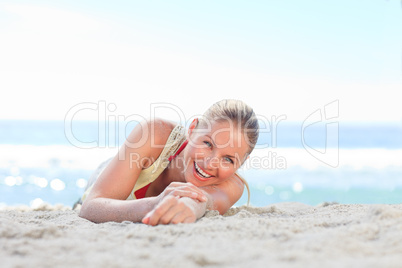 A woman sunbathing at the beach