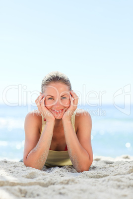 Lovely woman sunbathing at the beach