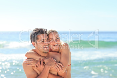 Happy lovers at the beach