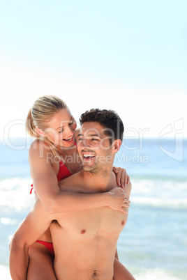 Beautiful man having girlfriend a piggyback