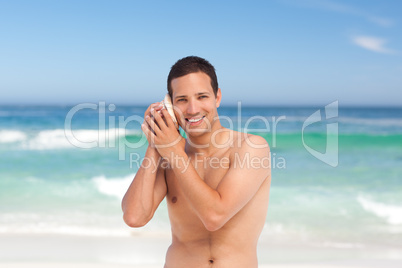 Man listening to his shell