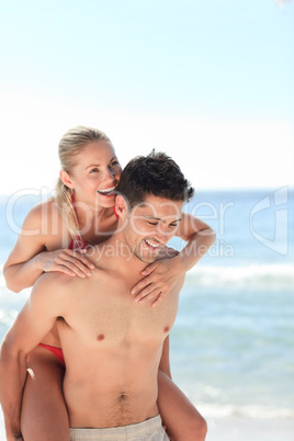 Beautiful man having girlfriend a piggyback