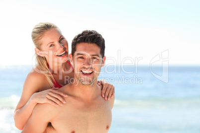 Beautiful man having girlfriend a piggyback