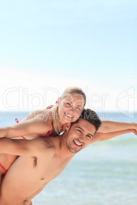 Beautiful man having girlfriend a piggyback