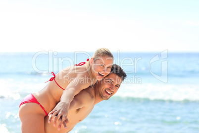 Beautiful man having girlfriend a piggyback