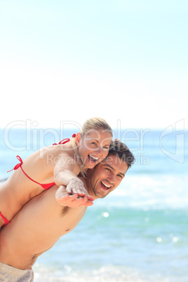 Beautiful man having girlfriend a piggyback