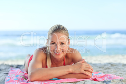 Beautiful woman lying down on the beach