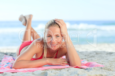 Beautiful woman lying down on the beach