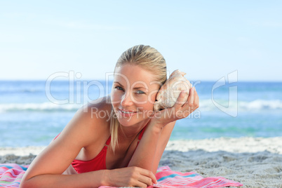 Woman listening to a shell
