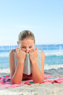 Adorable woman reading a book on the beach