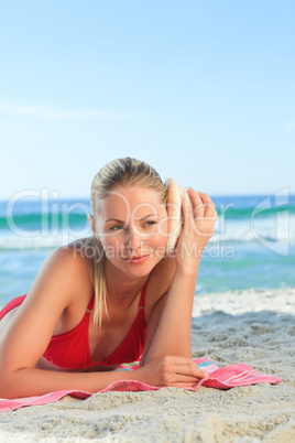Woman listening to a shell
